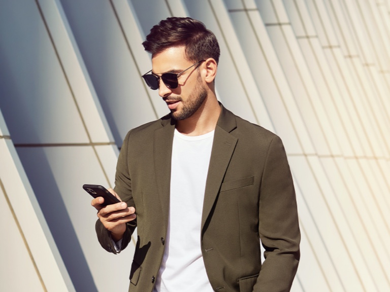 A man visiting the Mercedes me Store on his mobile phone. A man visiting the Mercedes me Store on his mobile phone.