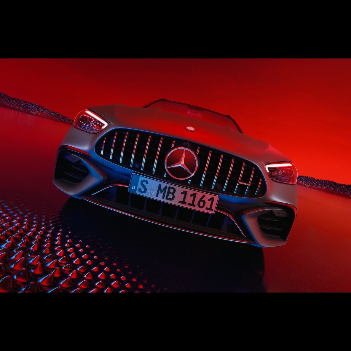 Mercedes-AMG C 63 S E PERFORMANCE in the front view against a red background.