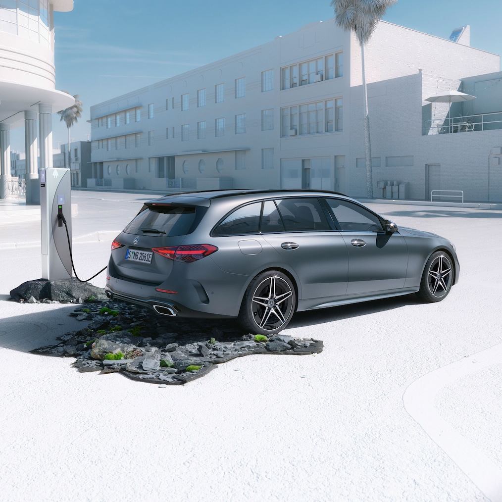 Dynamic view of a Mercedes-Benz C-Class Estate (driving shot) or standing at a charging station.