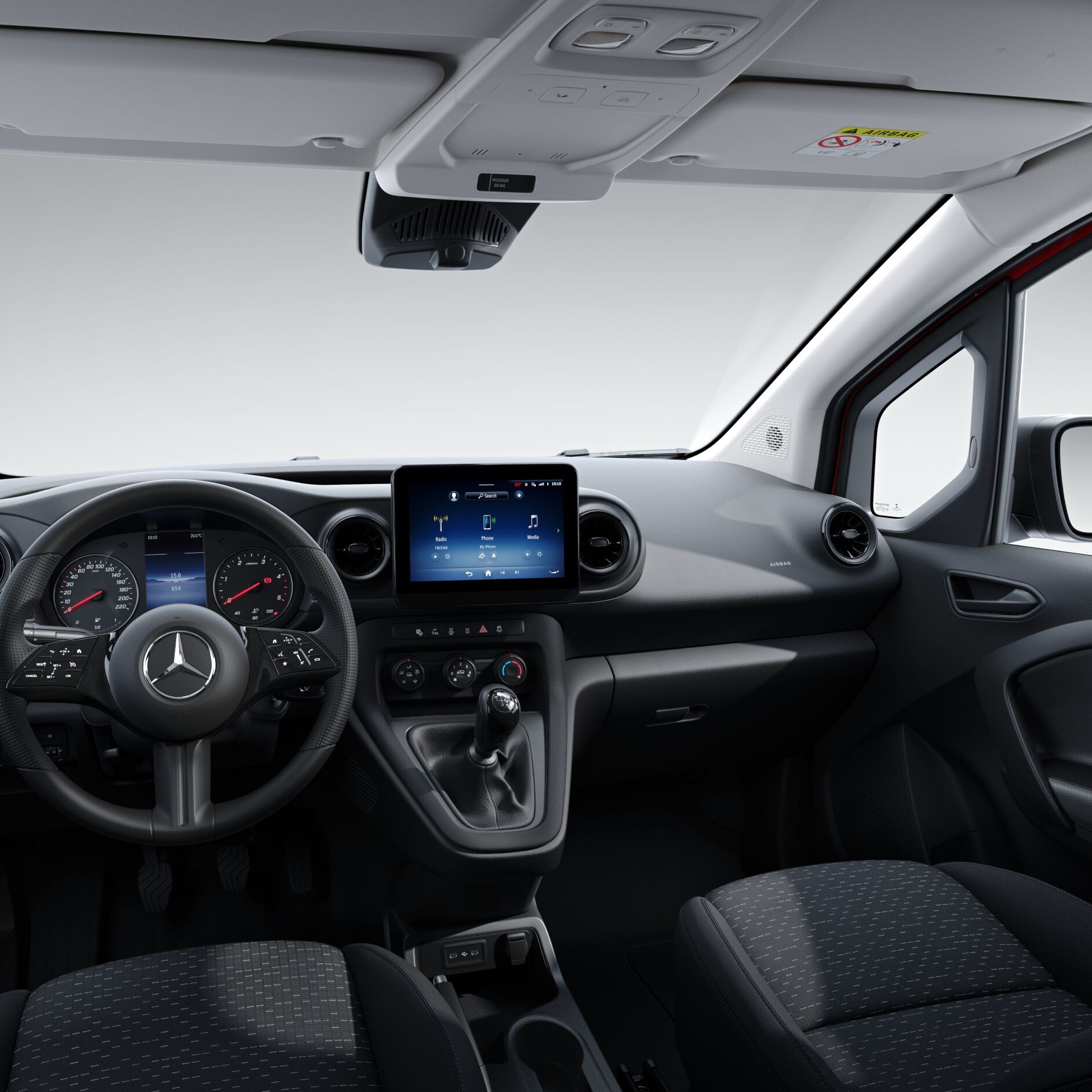 A person's hand operating the touchscreen of the MBUX multimedia system in the Mercedes-Benz Citan.