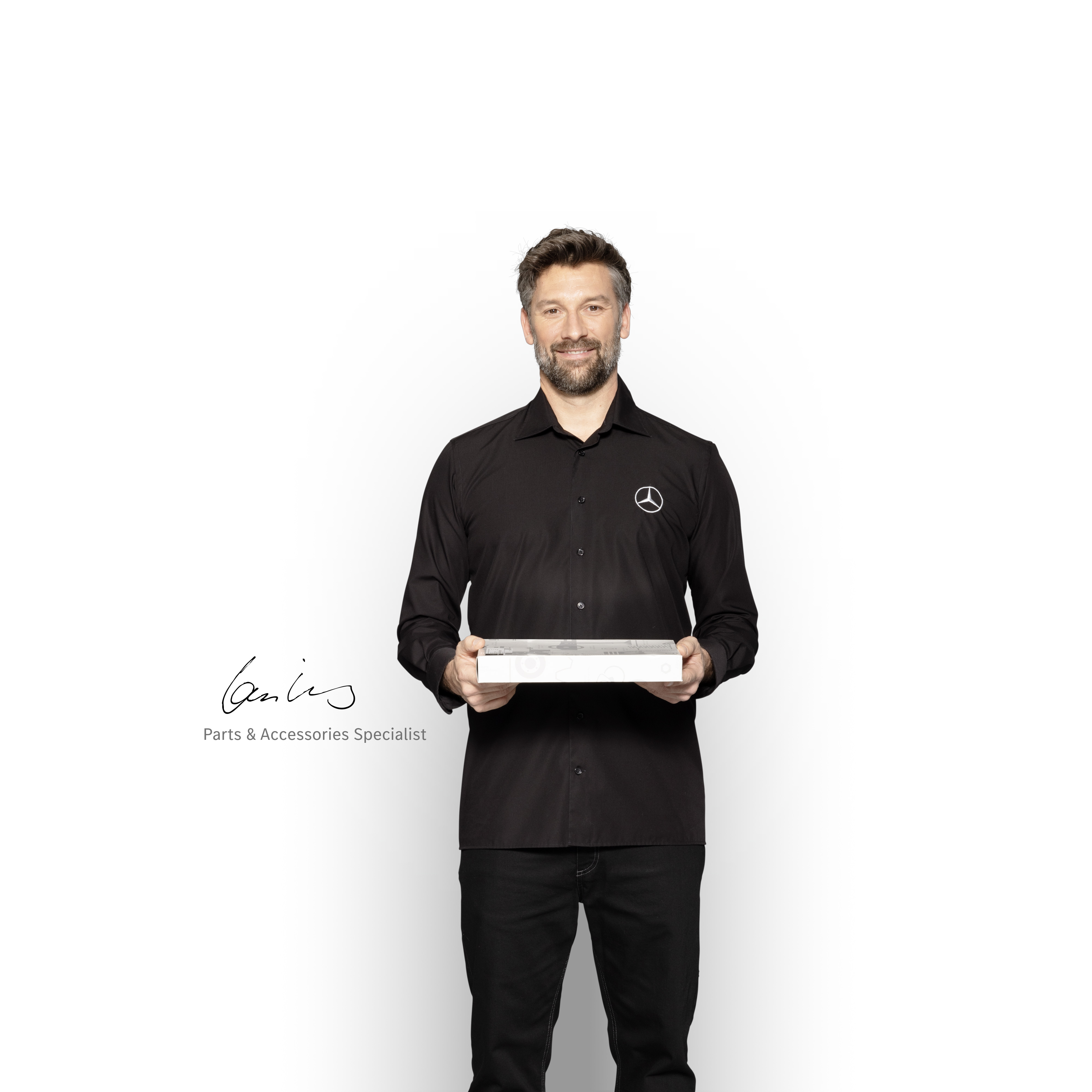 Mercedes-Benz | Vans Quality GenuineParts Mercedes-Benz Inhouse Technician with a box in his hands to show Mercedes-Benz genuine parts.