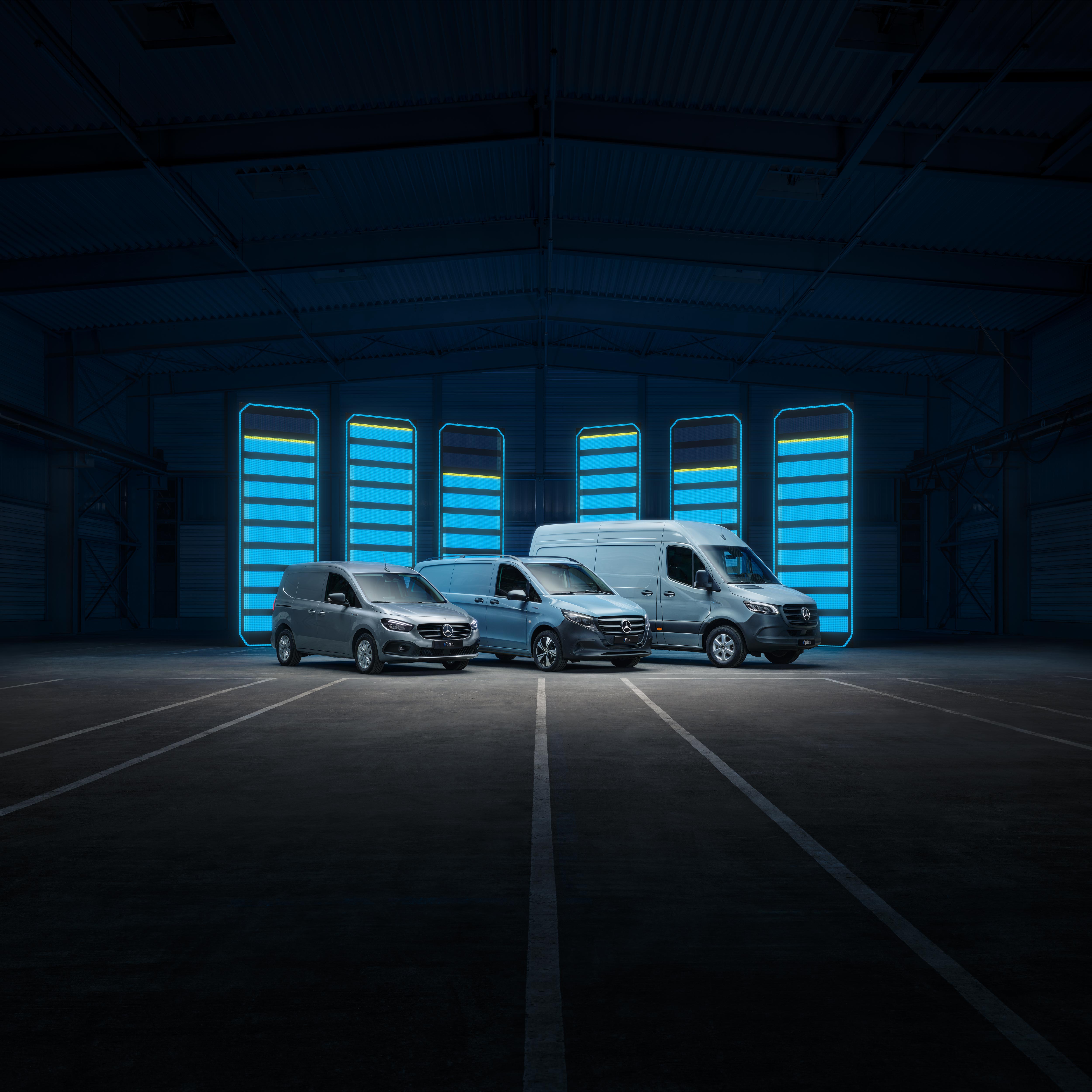 eCitan, eVito & eSprinter Panel Vans | Mercedes-Benz Vans Mercedes-Benz eCitan, eVito and eSprinter electric panel vans parked in a row in front of a bue battery charging graphic.